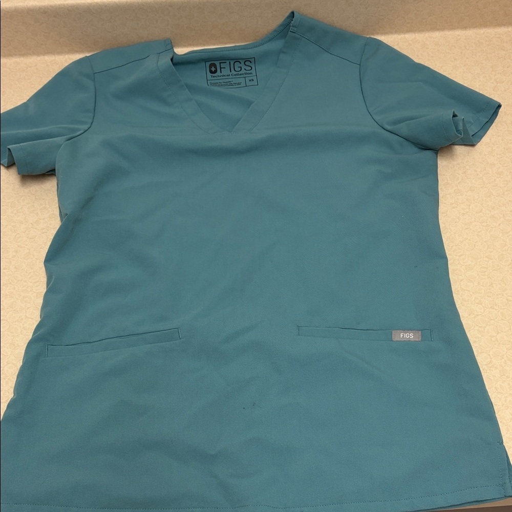 Figs Ocean Blue Scrub Top style FW1100
Size XS